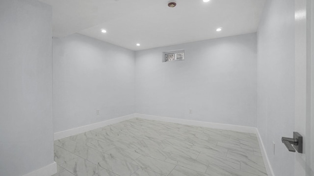 unfurnished room featuring recessed lighting, baseboards, and marble finish floor