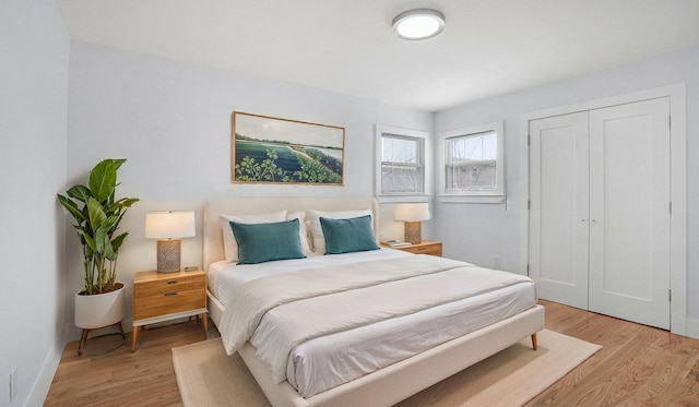 bedroom featuring a closet and light wood finished floors