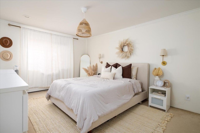 bedroom with light carpet, crown molding, and a baseboard radiator