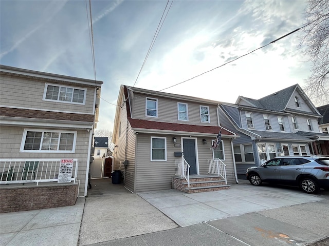 townhome / multi-family property featuring concrete driveway