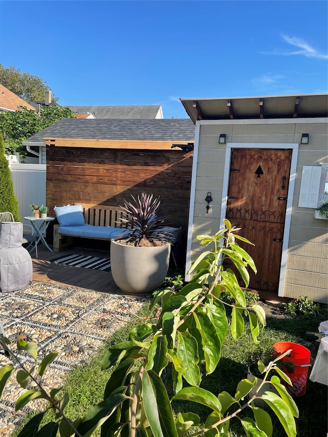10719 96th St, Ozone Park, NY 11417 - doorway to property featuring a shingled roof