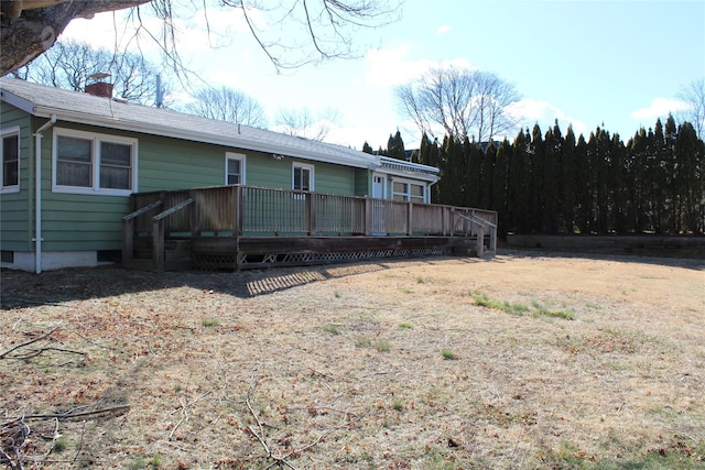 exterior space with a deck and a chimney