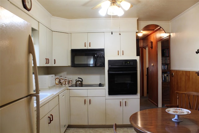 kitchen with crown molding, arched walkways, white cabinets, black appliances, and a ceiling fan