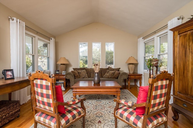 living area with lofted ceiling and light wood-style flooring