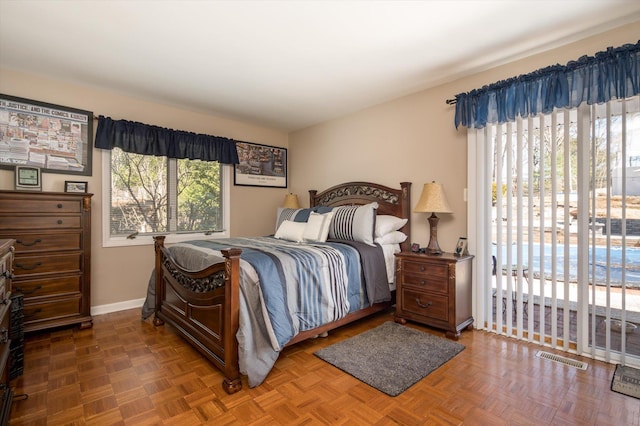 bedroom with visible vents, baseboards, and access to outside