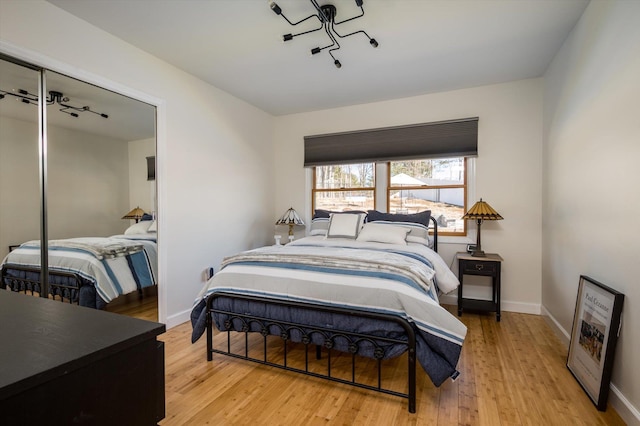 bedroom with baseboards and wood finished floors