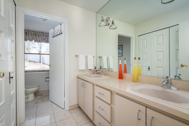 full bath featuring a sink, toilet, double vanity, and tile patterned flooring