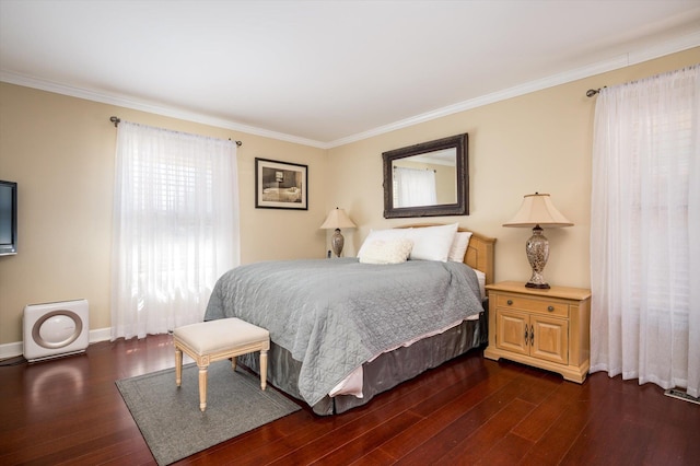 bedroom with crown molding, dark wood-type flooring, and baseboards