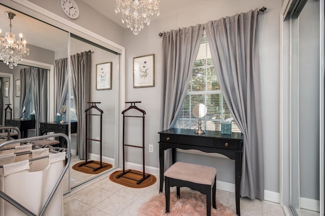 interior space featuring baseboards, marble finish floor, and a chandelier