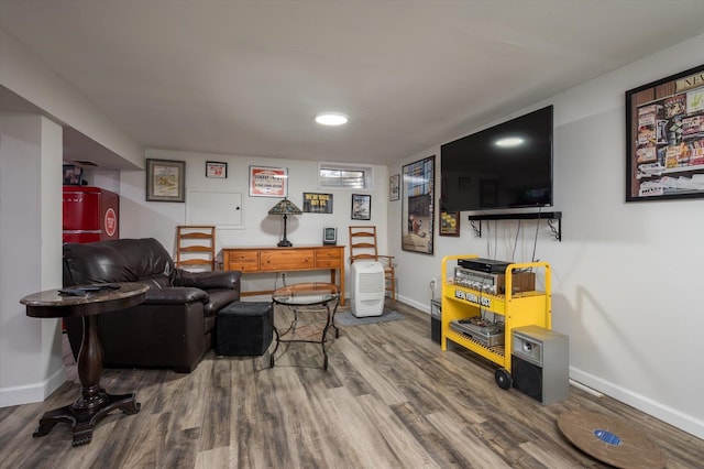 living area featuring baseboards and wood finished floors