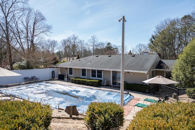 view of swimming pool featuring a patio area, fence, and a fenced in pool