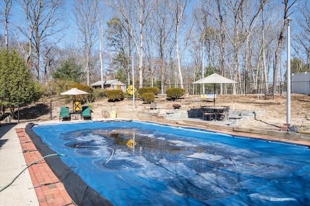 view of swimming pool with fence