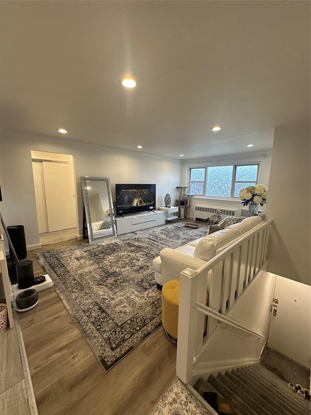 living room with recessed lighting, radiator, and wood finished floors