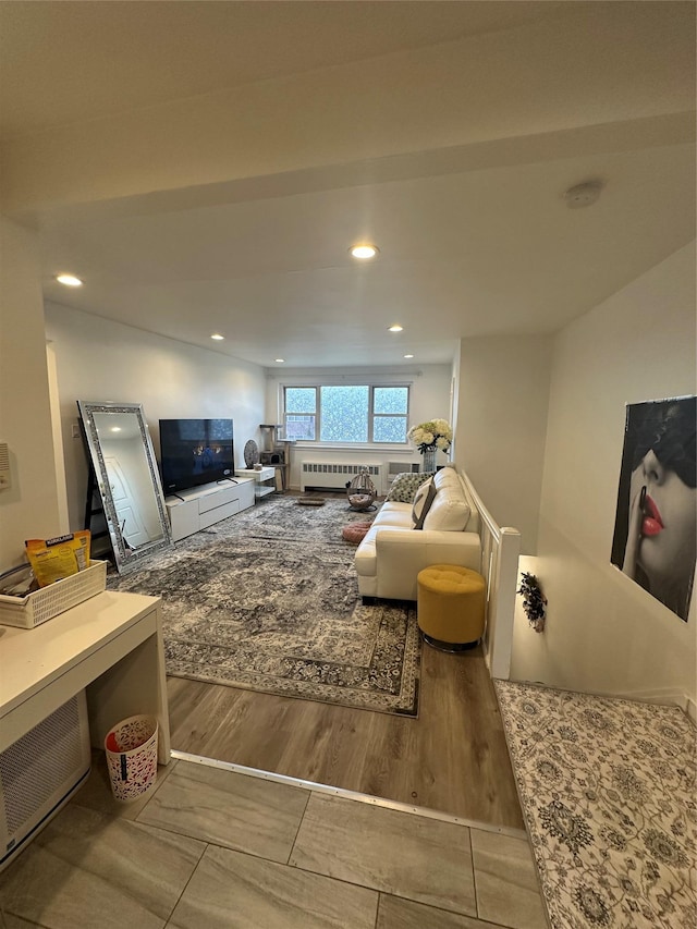 living room featuring recessed lighting, radiator heating unit, and wood finished floors