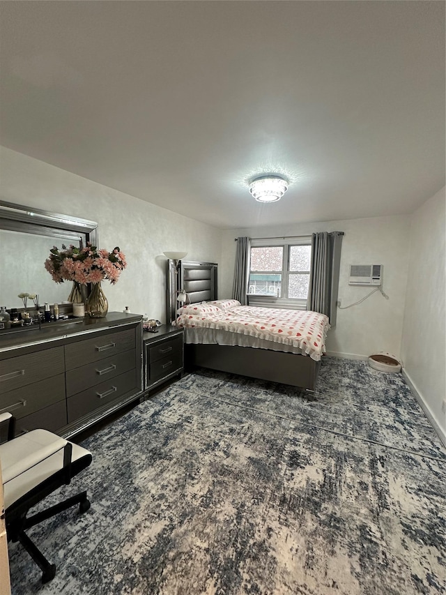 bedroom featuring baseboards, dark colored carpet, and a wall mounted AC