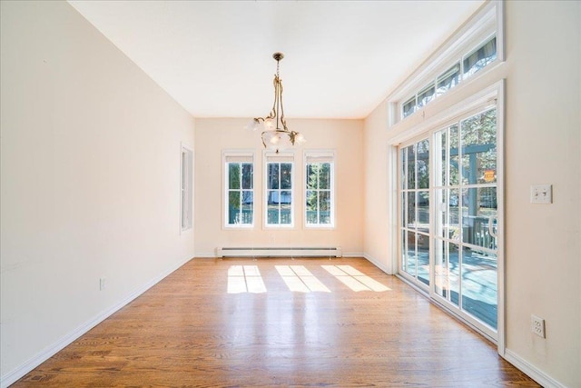 69 Leber Rd, Blauvelt, NY 10913 - unfurnished dining area featuring baseboards, a baseboard heating unit, wood finished floors, and a chandelier