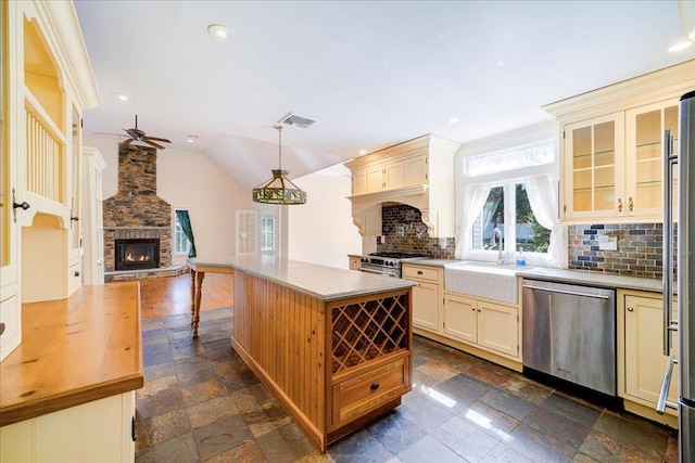 69 Leber Rd, Blauvelt, NY 10913 - kitchen featuring a sink, appliances with stainless steel finishes, a fireplace, and cream cabinetry