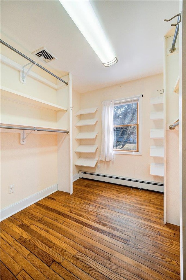 69 Leber Rd, Blauvelt, NY 10913 - walk in closet with visible vents, wood finished floors, and baseboard heating