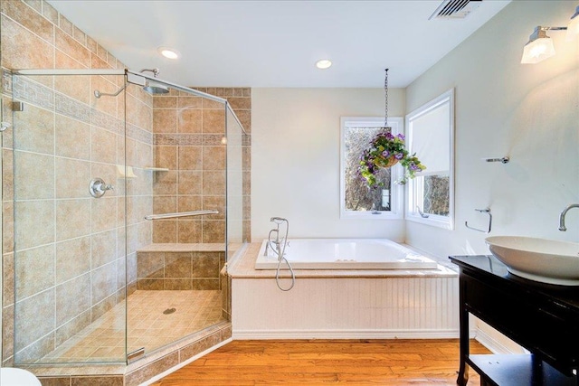 69 Leber Rd, Blauvelt, NY 10913 - full bath featuring a garden tub, visible vents, a shower stall, wood finished floors, and vanity