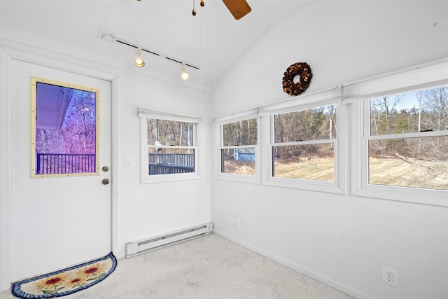 unfurnished sunroom featuring track lighting, ceiling fan, lofted ceiling, and a baseboard radiator