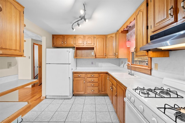 kitchen featuring white appliances, light tile patterned floors, open shelves, a sink, and light countertops