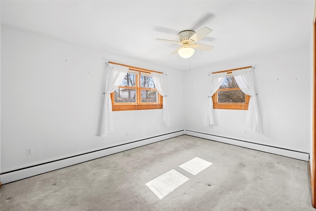 carpeted empty room with baseboard heating and a ceiling fan