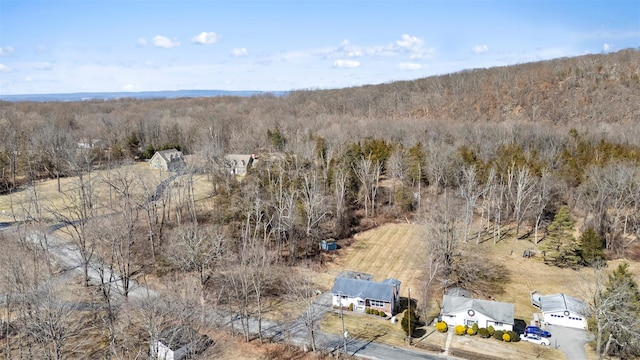 drone / aerial view with a wooded view