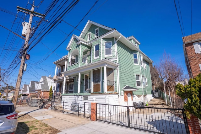 view of front of house featuring a fenced front yard and a porch