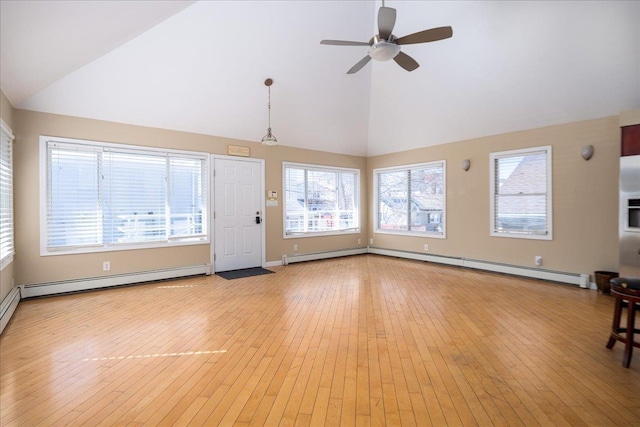 unfurnished living room featuring ceiling fan, light wood-style flooring, baseboard heating, and high vaulted ceiling