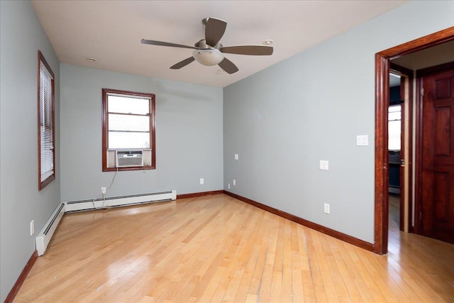 unfurnished room featuring cooling unit, baseboards, light wood-style floors, and baseboard heating