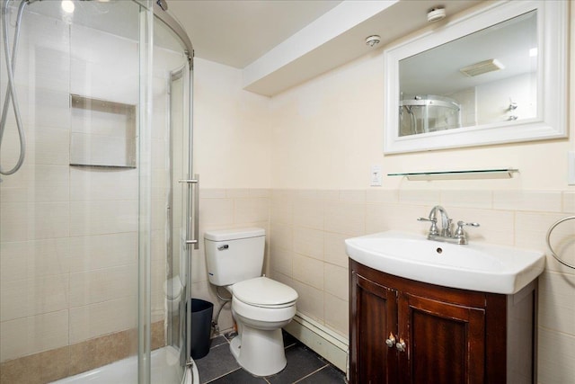 full bath featuring a wainscoted wall, toilet, a stall shower, tile patterned floors, and vanity