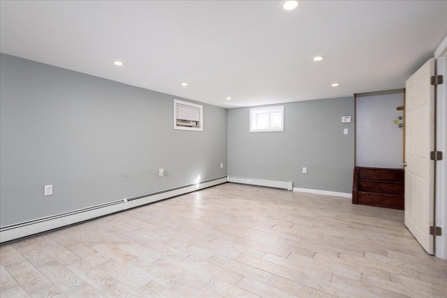 empty room with light wood-style flooring, recessed lighting, and baseboard heating