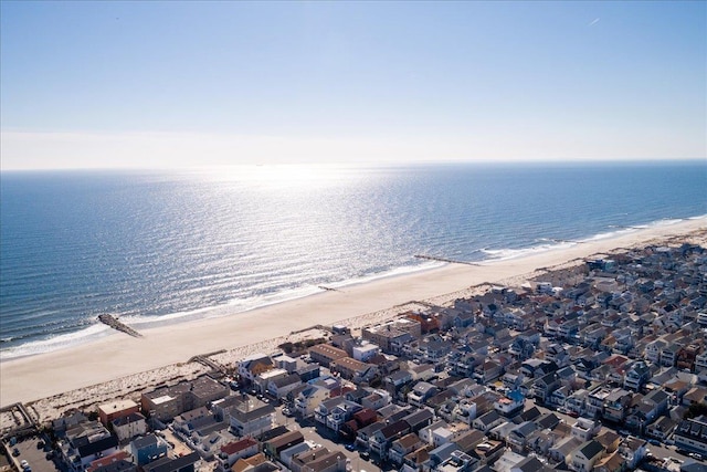 aerial view with a residential view, a view of the beach, and a water view