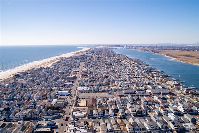 bird's eye view with a view of the beach, a water view, and a residential view