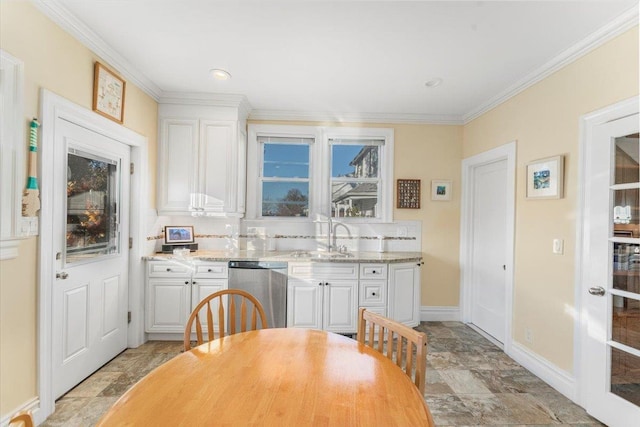 kitchen with a sink, backsplash, white cabinets, crown molding, and dishwasher