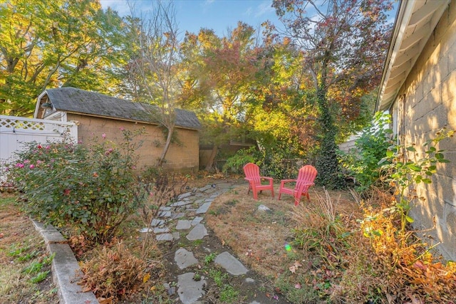 view of yard with an outbuilding and fence