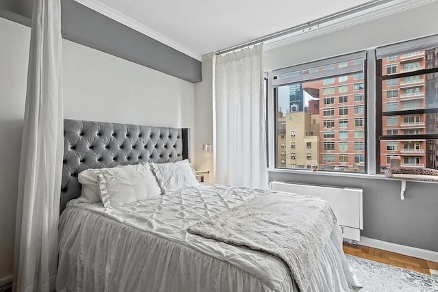 bedroom with crown molding, radiator heating unit, and baseboards