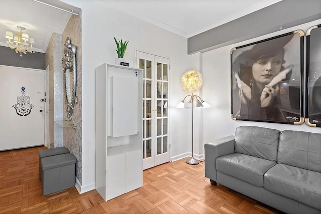 living area featuring baseboards, a notable chandelier, and crown molding