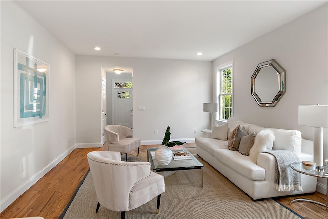 living area featuring recessed lighting, baseboards, and wood finished floors