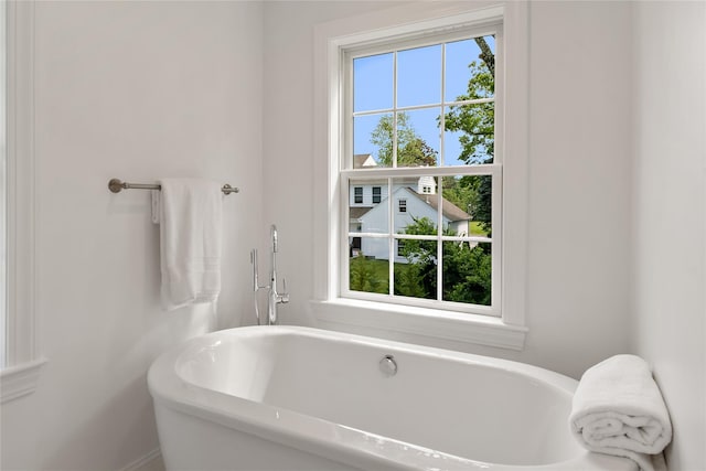 full bathroom featuring plenty of natural light and a soaking tub