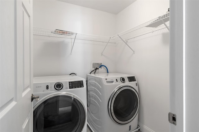 washroom with laundry area and washer and dryer