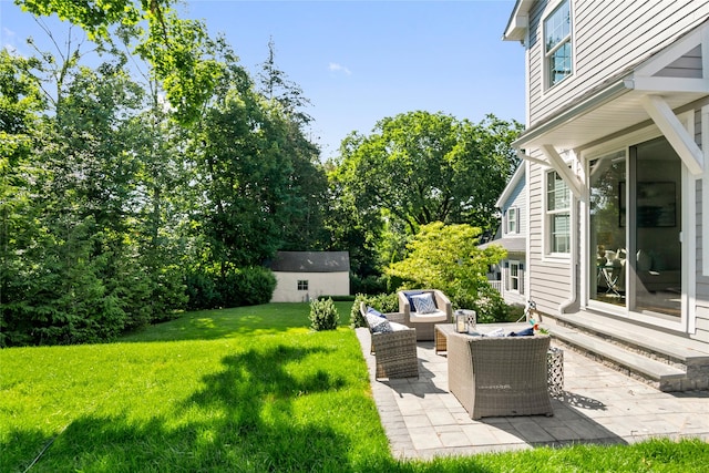 view of yard featuring outdoor lounge area, a patio, and an outdoor structure