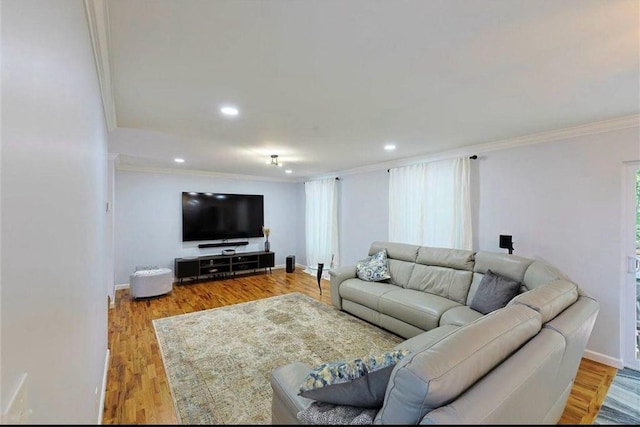 living area with recessed lighting, wood finished floors, baseboards, and ornamental molding