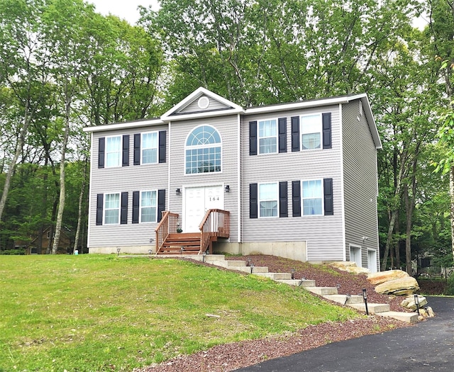 164 Lake Shore Dr E, Rock Hill, NY 12775 - view of front of house with an attached garage, a front yard, and asphalt driveway