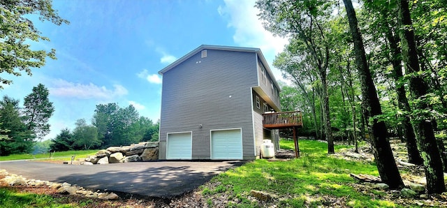164 Lake Shore Dr E, Rock Hill, NY 12775 - view of property exterior with an attached garage, asphalt driveway, and a deck