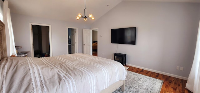 164 Lake Shore Dr E, Rock Hill, NY 12775 - bedroom featuring a chandelier, vaulted ceiling, wood finished floors, and a wood stove