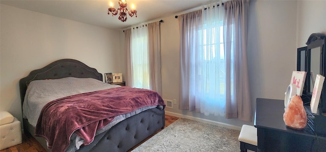 164 Lake Shore Dr E, Rock Hill, NY 12775 - bedroom featuring wood finished floors and a chandelier