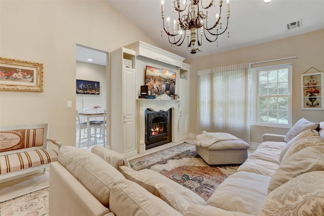 living area with visible vents, a fireplace with flush hearth, an inviting chandelier, light tile patterned flooring, and vaulted ceiling