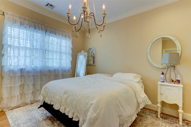 bedroom with wood finished floors, baseboards, visible vents, an inviting chandelier, and ornamental molding