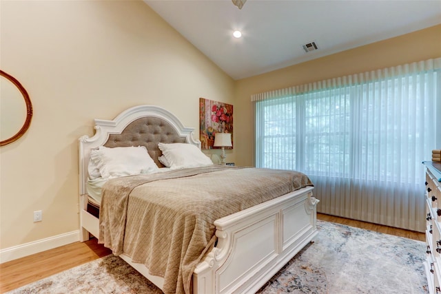 bedroom featuring baseboards, visible vents, recessed lighting, vaulted ceiling, and light wood-type flooring